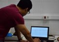 Clinical neurophysiologist reviewing EEG waveform data