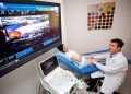 Doctor performing ultrasound examination on patient leg for neuromuscular assessment