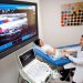Doctor performing ultrasound examination on patient leg for neuromuscular assessment